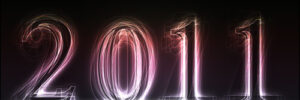 Glowing, stylized numbers forming "2011" on a dark background with light streak effects.