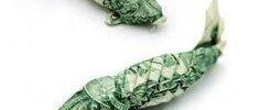 Two koi fish sculptures crafted from folded U.S. dollar bills displayed on a white background.