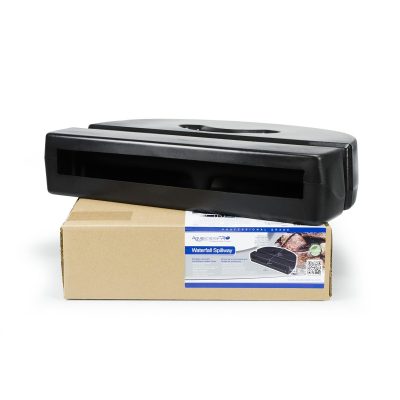 A black waterfall spillway sits on top of a cardboard box with a product label featuring an image of the spillway.