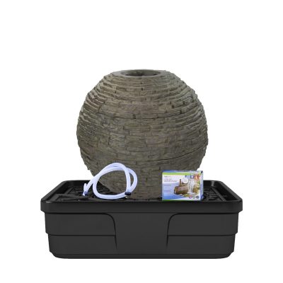 A stacked stone sphere fountain kit with tubing, a plastic reservoir, and product packaging displayed in front.